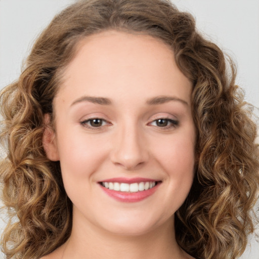 Joyful white young-adult female with long  brown hair and green eyes