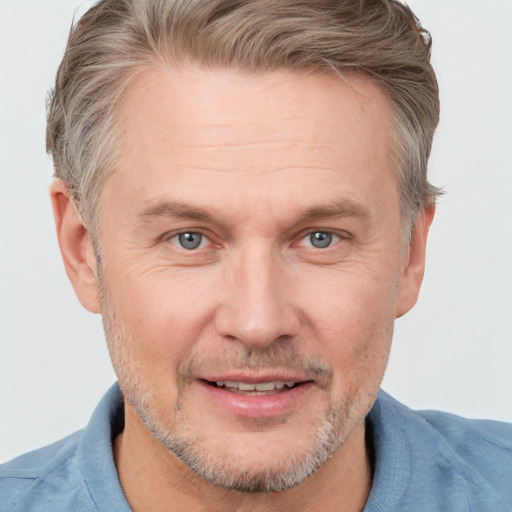 Joyful white adult male with short  brown hair and grey eyes