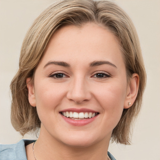 Joyful white young-adult female with medium  brown hair and blue eyes