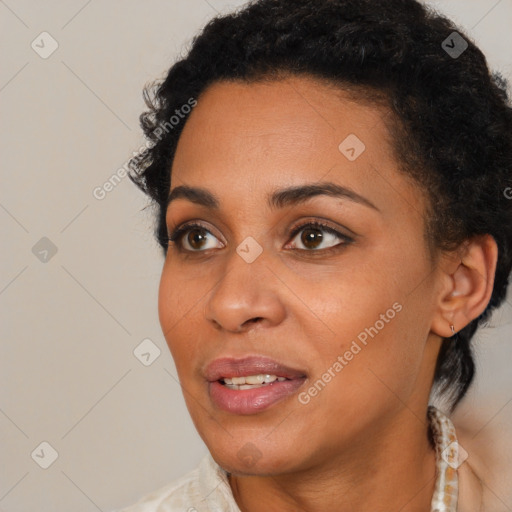 Joyful black young-adult female with short  black hair and brown eyes