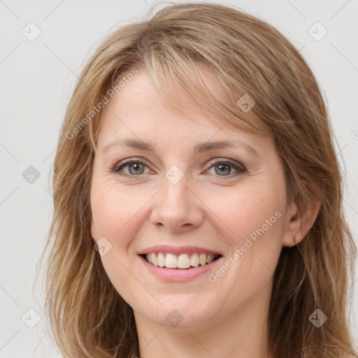 Joyful white young-adult female with long  brown hair and blue eyes