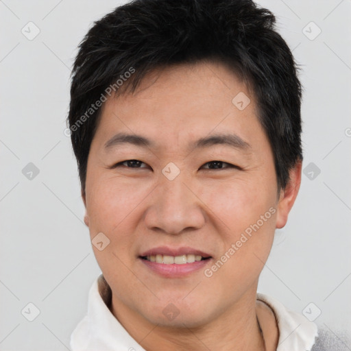 Joyful asian adult male with short  brown hair and brown eyes