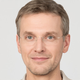 Joyful white adult male with short  brown hair and grey eyes