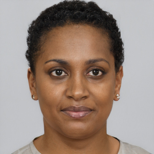 Joyful black young-adult female with short  brown hair and brown eyes