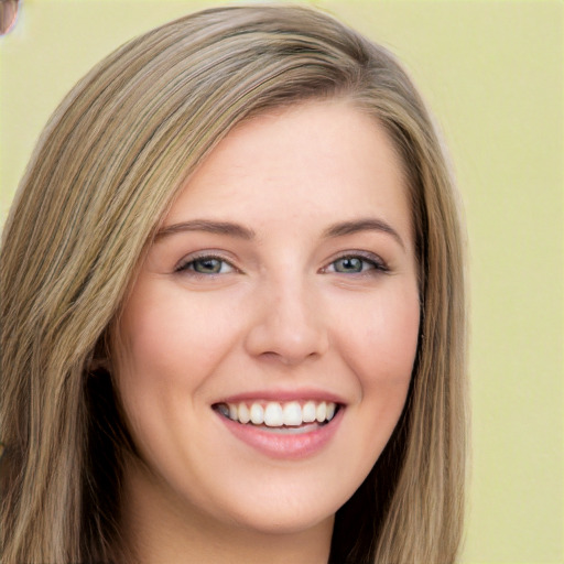 Joyful white young-adult female with long  brown hair and green eyes