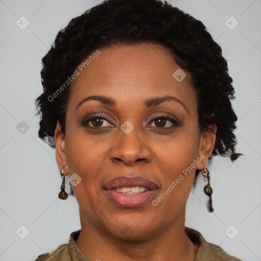 Joyful black adult female with short  brown hair and brown eyes