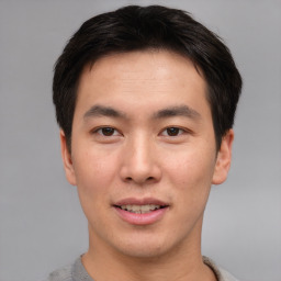 Joyful asian young-adult male with short  brown hair and brown eyes