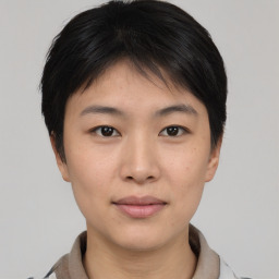 Joyful asian young-adult female with short  brown hair and brown eyes