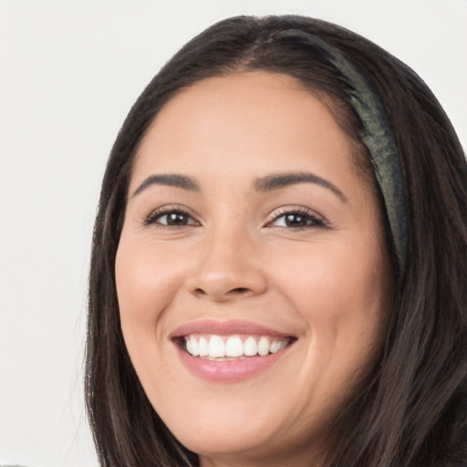 Joyful white young-adult female with long  black hair and brown eyes