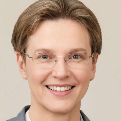 Joyful white adult female with short  brown hair and grey eyes