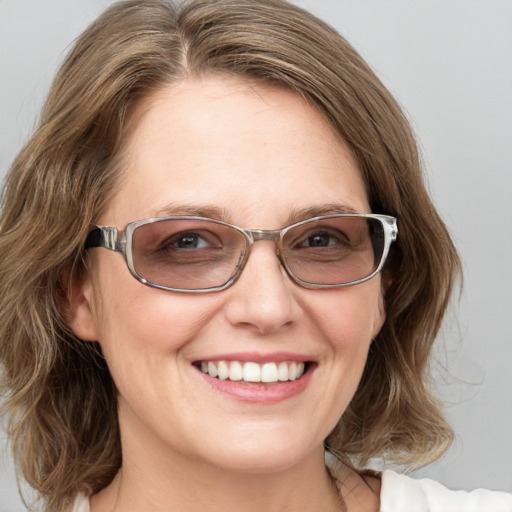 Joyful white young-adult female with medium  brown hair and blue eyes