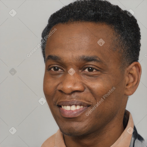 Joyful black adult male with short  brown hair and brown eyes