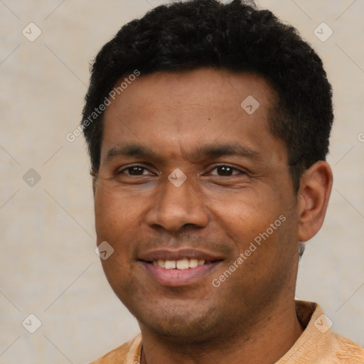 Joyful latino adult male with short  black hair and brown eyes