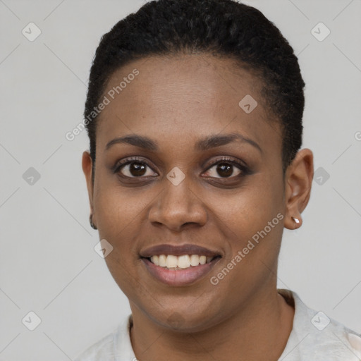 Joyful black young-adult female with short  black hair and brown eyes