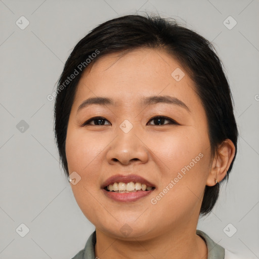 Joyful asian young-adult female with medium  black hair and brown eyes