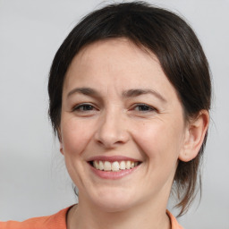 Joyful white adult female with medium  brown hair and brown eyes