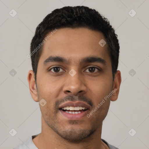 Joyful latino young-adult male with short  black hair and brown eyes