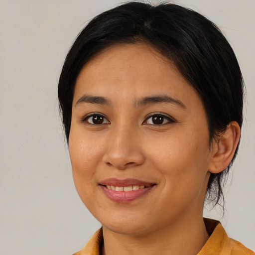 Joyful asian young-adult female with medium  brown hair and brown eyes
