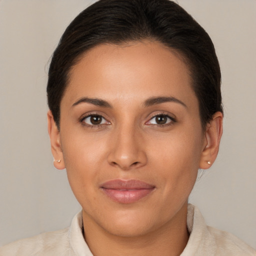 Joyful latino young-adult female with short  brown hair and brown eyes