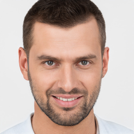 Joyful white young-adult male with short  brown hair and brown eyes