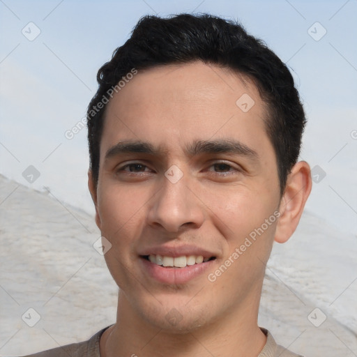 Joyful white young-adult male with short  black hair and brown eyes