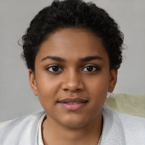 Joyful black young-adult female with short  brown hair and brown eyes
