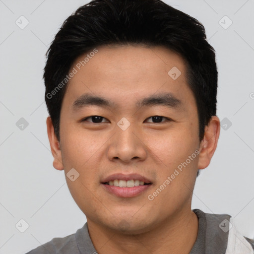 Joyful asian young-adult male with short  black hair and brown eyes