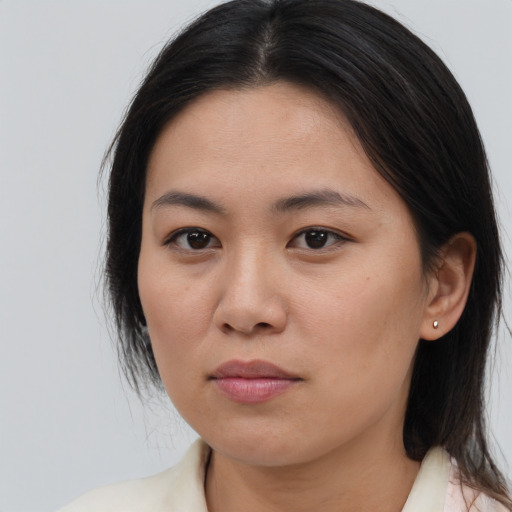 Joyful asian young-adult female with medium  brown hair and brown eyes