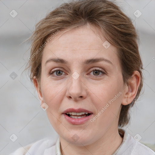 Joyful white adult female with medium  brown hair and blue eyes