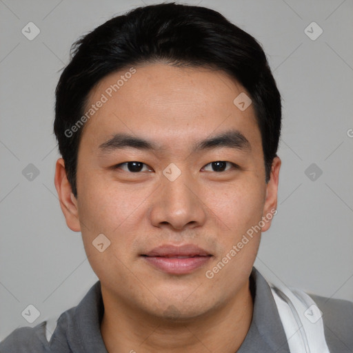 Joyful asian young-adult male with short  black hair and brown eyes