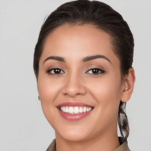 Joyful white young-adult female with long  brown hair and brown eyes