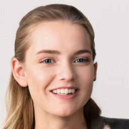 Joyful white young-adult female with long  brown hair and blue eyes