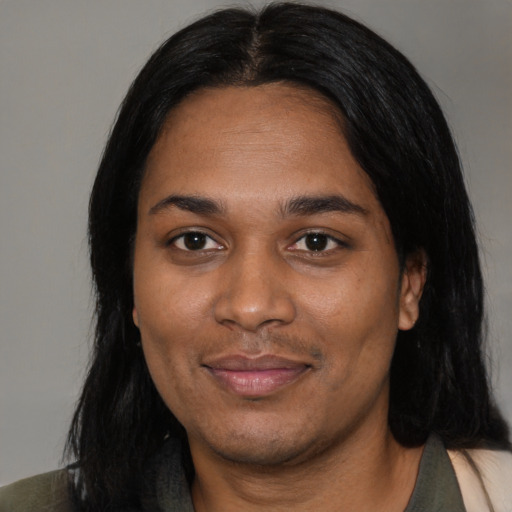 Joyful black young-adult female with medium  black hair and brown eyes