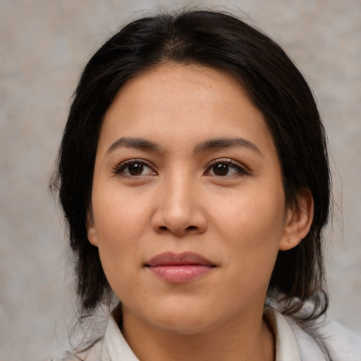 Joyful latino young-adult female with medium  brown hair and brown eyes