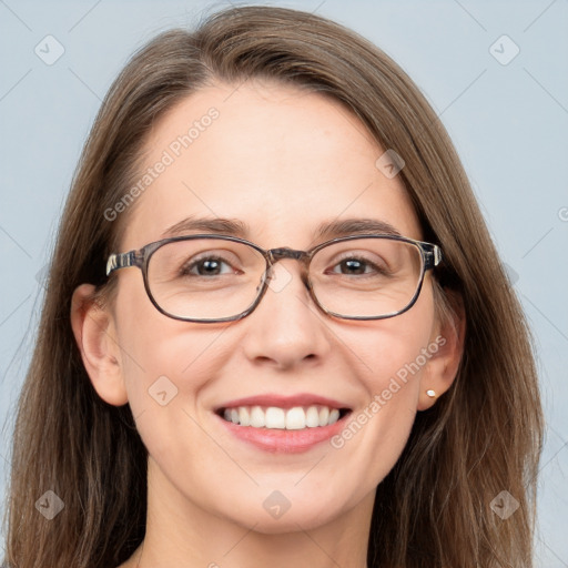 Joyful white adult female with long  brown hair and grey eyes