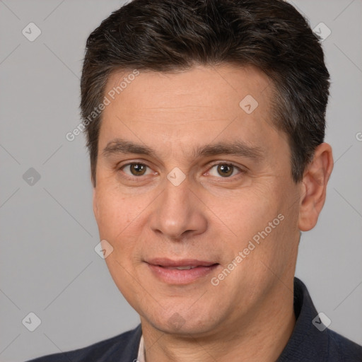 Joyful white adult male with short  brown hair and brown eyes