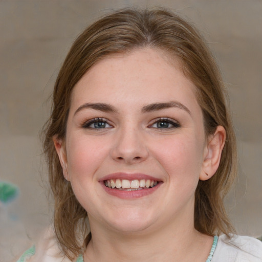 Joyful white young-adult female with medium  brown hair and blue eyes