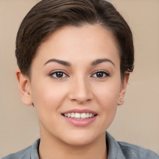 Joyful white young-adult female with short  brown hair and brown eyes