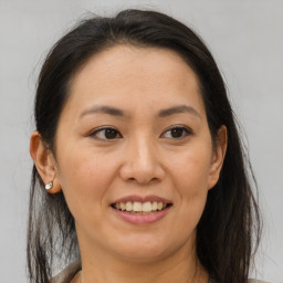 Joyful white adult female with medium  brown hair and brown eyes