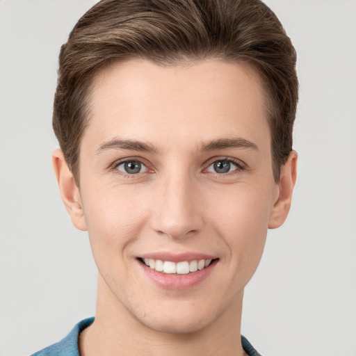 Joyful white young-adult female with short  brown hair and grey eyes