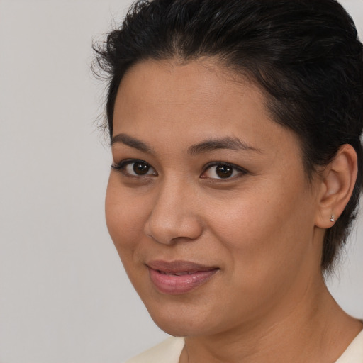 Joyful latino young-adult female with short  brown hair and brown eyes