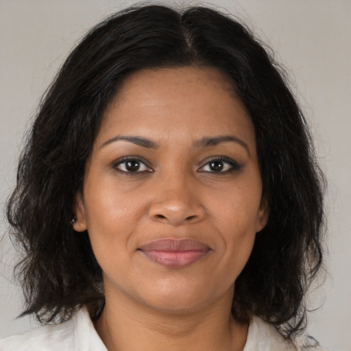 Joyful black young-adult female with medium  brown hair and brown eyes