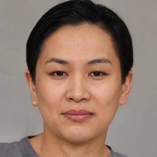 Joyful asian young-adult female with short  black hair and brown eyes