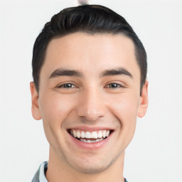 Joyful white young-adult male with short  black hair and brown eyes