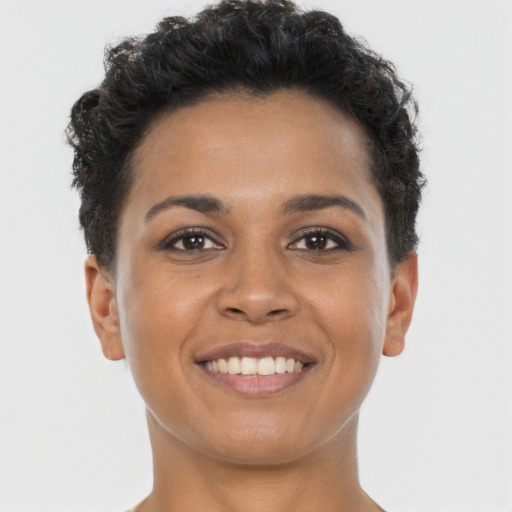 Joyful black young-adult female with short  brown hair and brown eyes