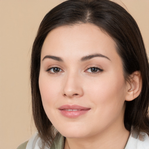 Joyful white young-adult female with medium  brown hair and brown eyes