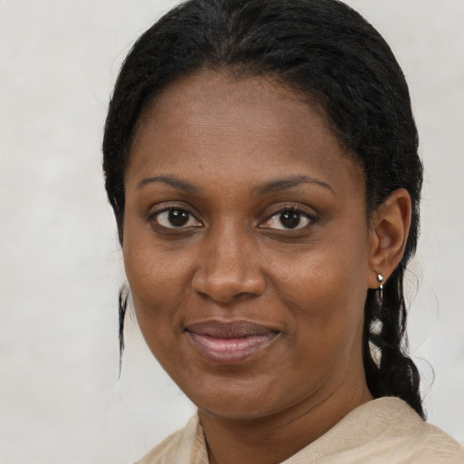 Joyful black young-adult female with short  brown hair and brown eyes
