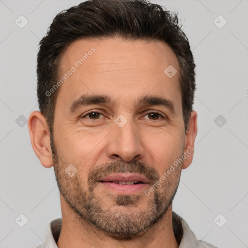 Joyful white adult male with short  brown hair and brown eyes