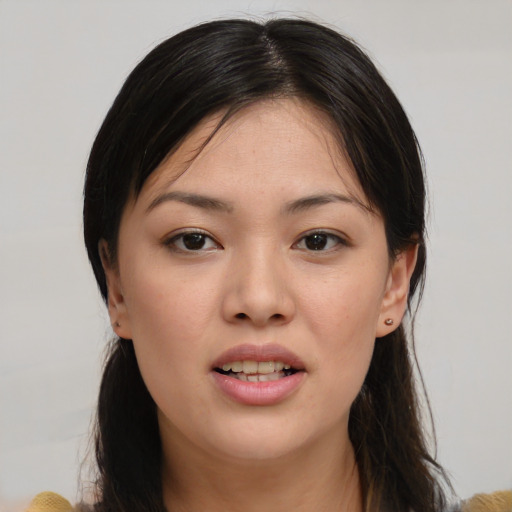 Joyful asian young-adult female with medium  brown hair and brown eyes