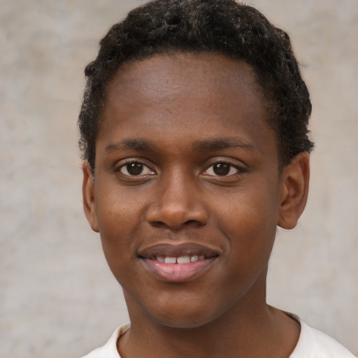 Joyful black young-adult male with short  brown hair and brown eyes